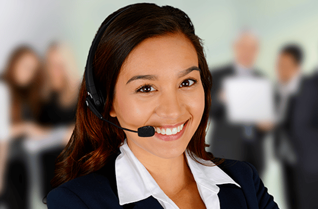 A woman wearing headphones and smiling for the camera.